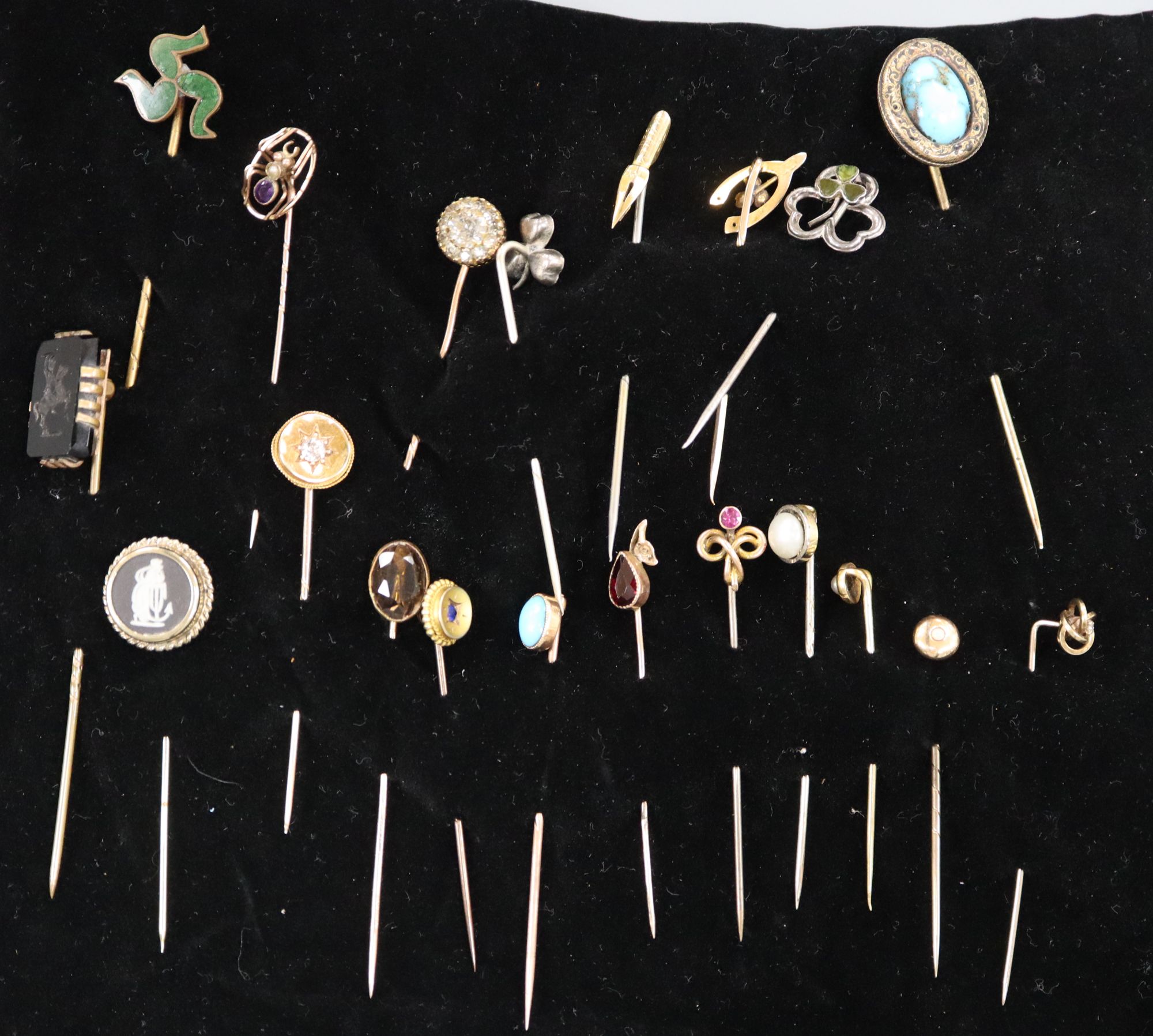 Twenty assorted Victorian and later mainly yellow metal and gem set stick pins